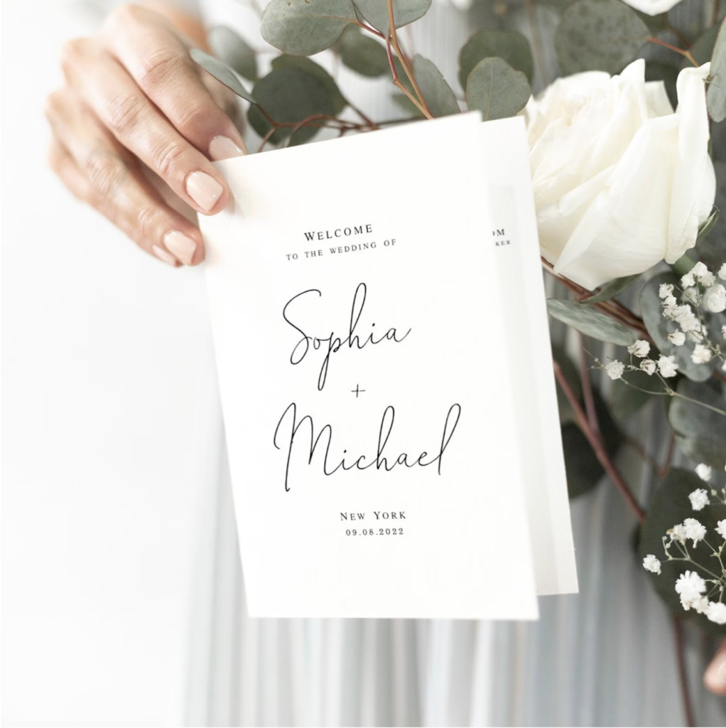 hand holding a traditional wedding program